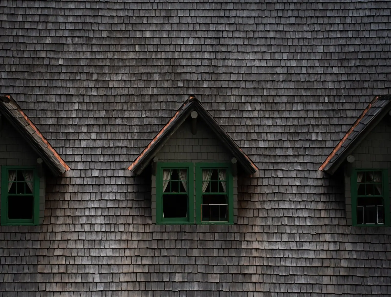 Cedar shingle roof with three dormer windows