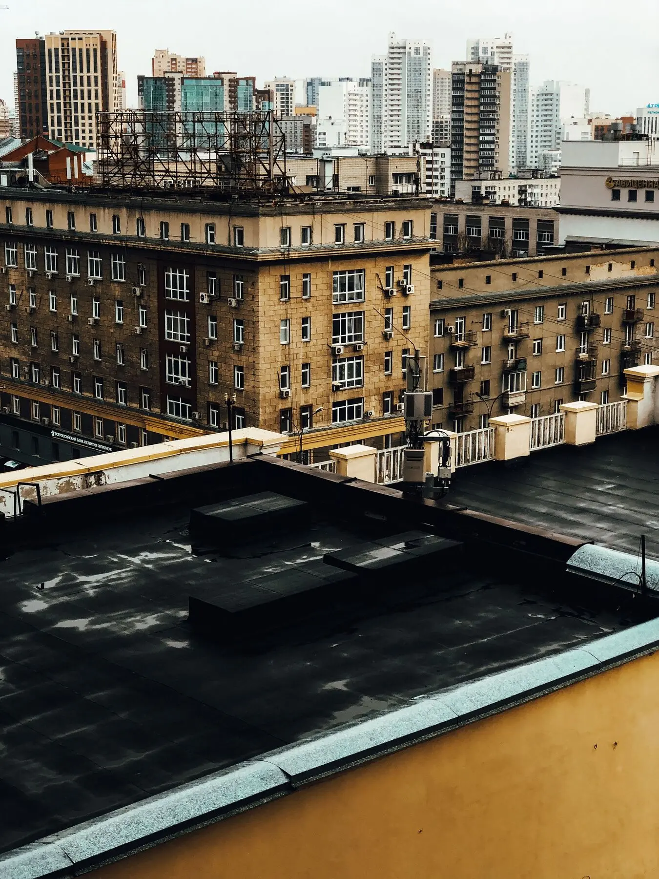 Flat roof of a city building with the skyline behind