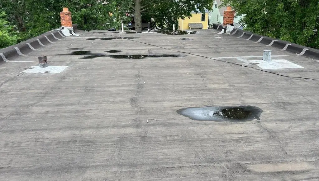 Flat roof with standing water before repair