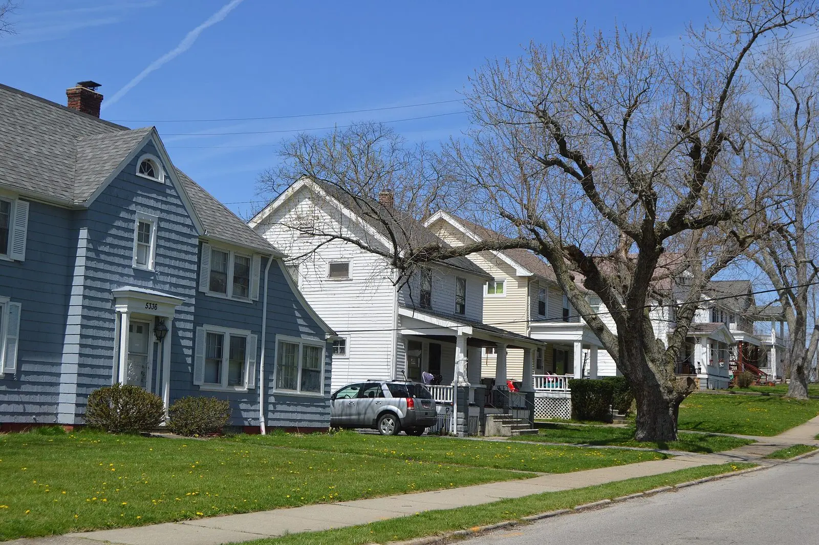 Older frame houses with front porches and shingle roofs on Vine Street in Maple Heights