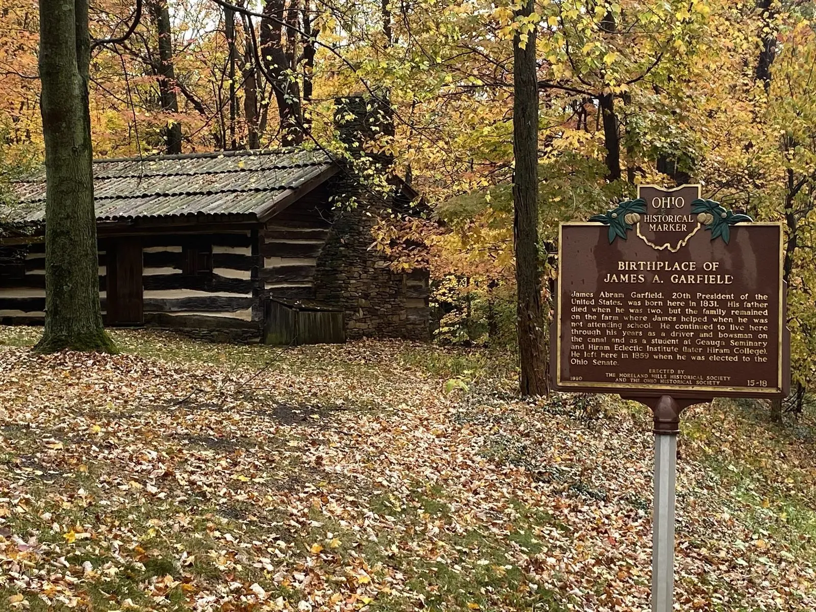 Replica log cabin and Ohio historical marker at the birthplace of President James A. Garfield in Moreland Hills, in autumn