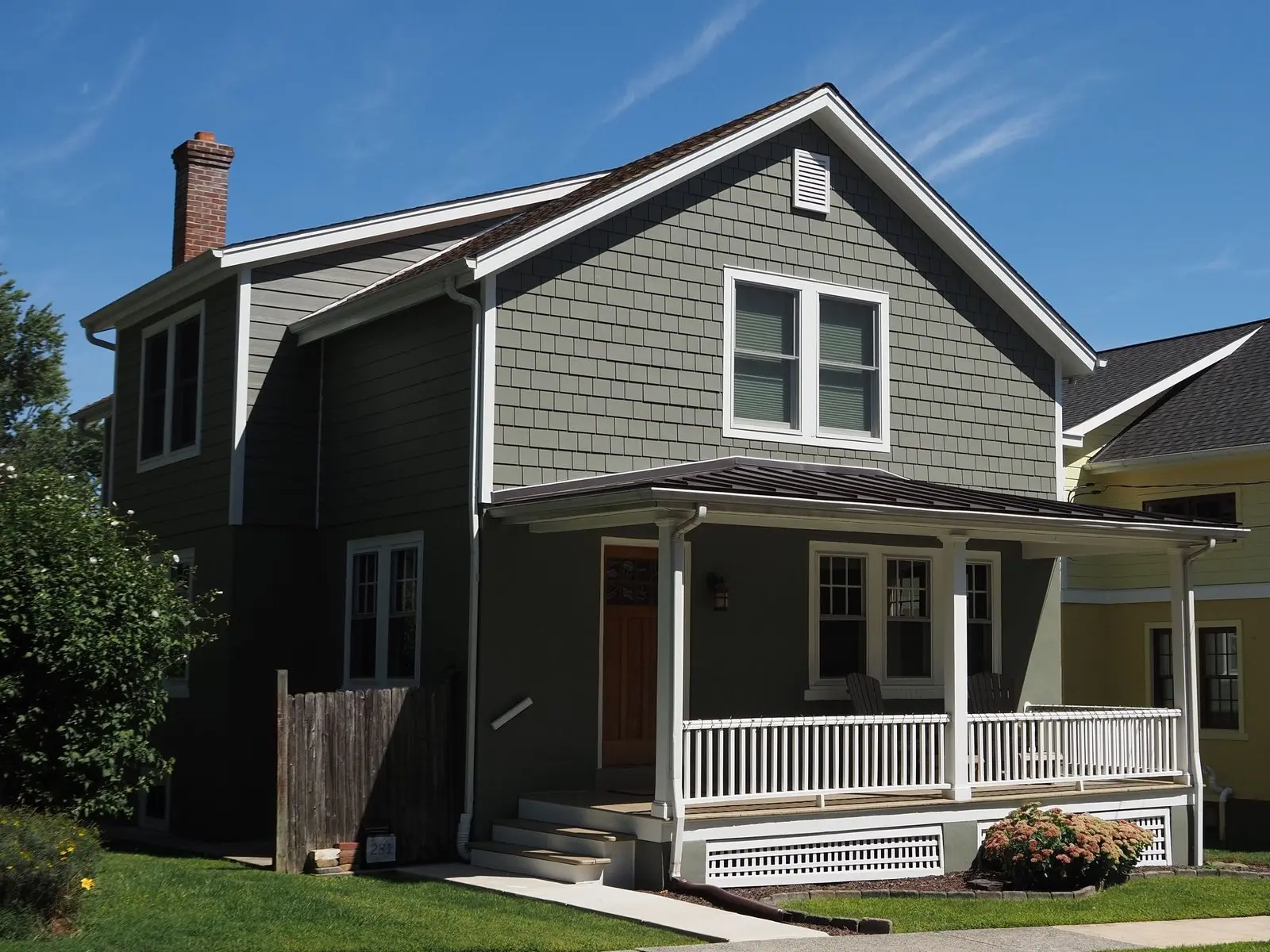 Two-story house with green lap siding and a front porch