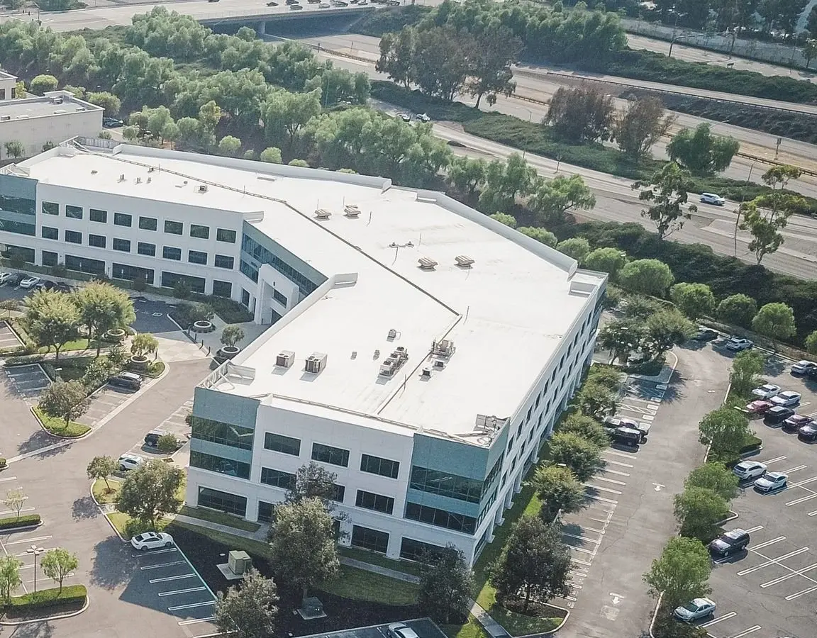 White membrane flat roof with rooftop units on an office building
